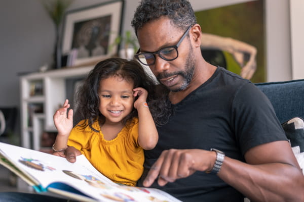 Dad reading to daughter